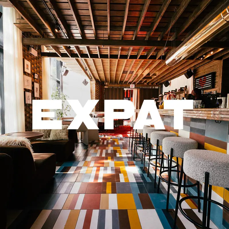 Expat restaurant interior with an overlaying logo